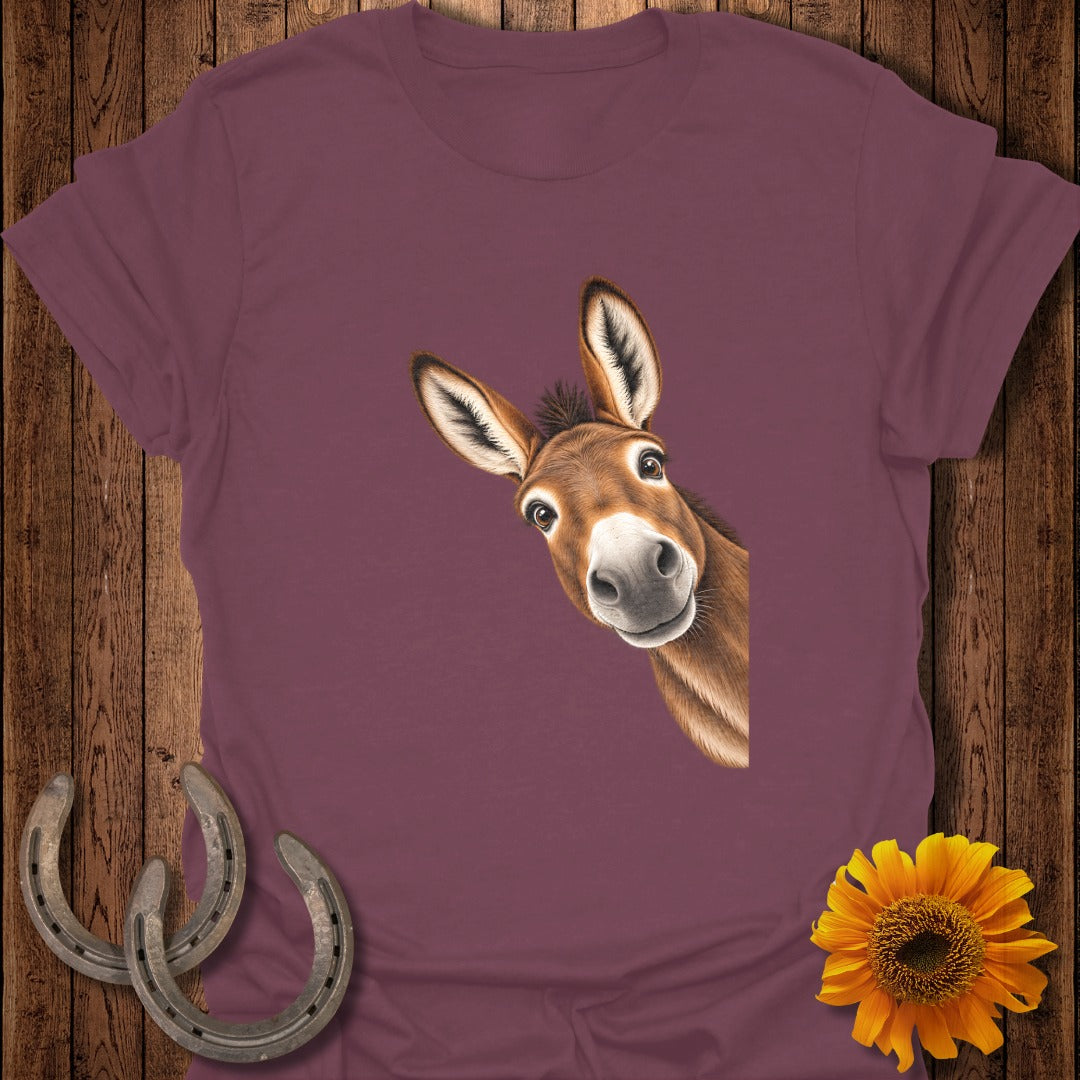 Maroon t-shirt with a peek-a-boo donkey illustration and rustic background elements.