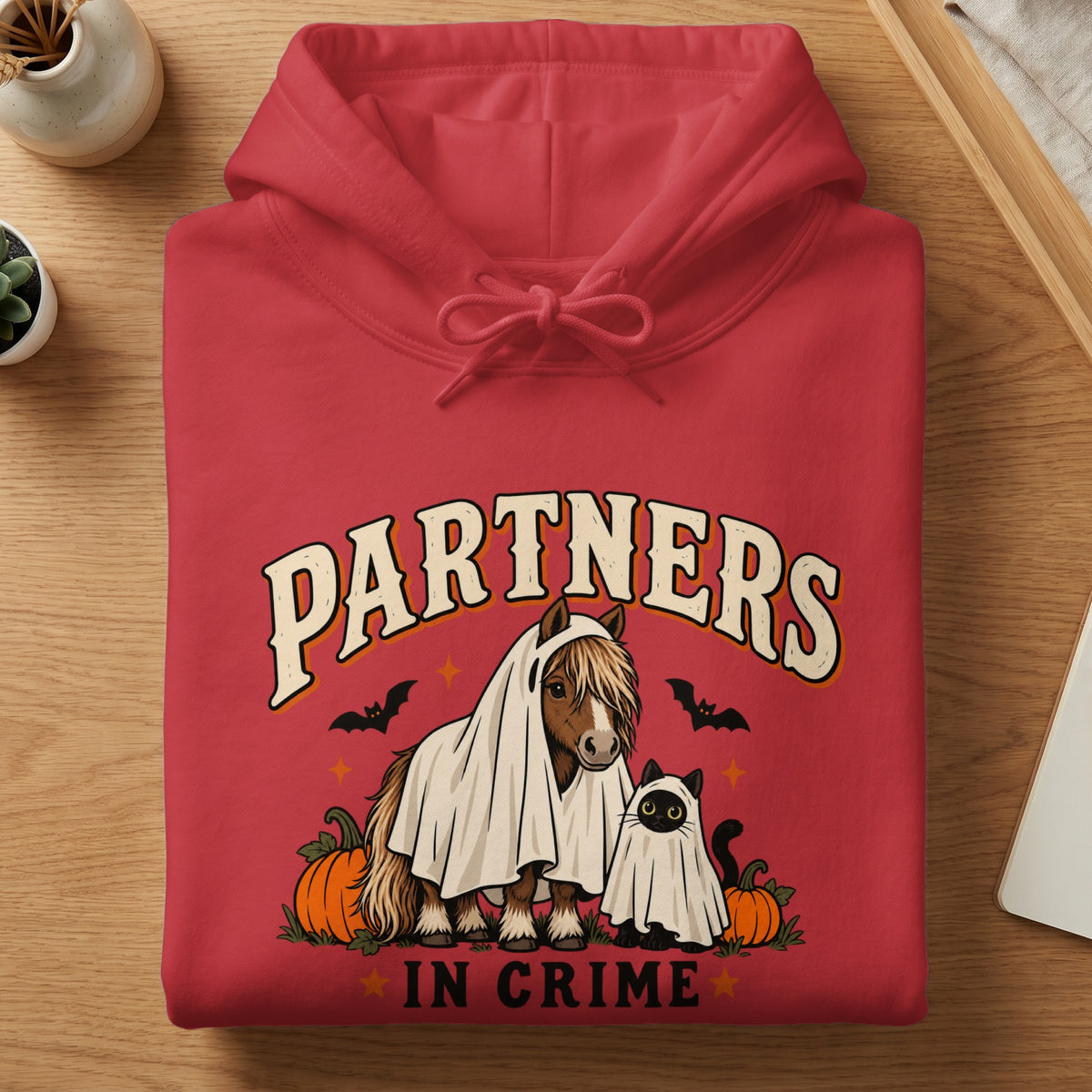 Red hoodie with ghost horse, cat, pumpkins, bats, and text "Partners in Crime."