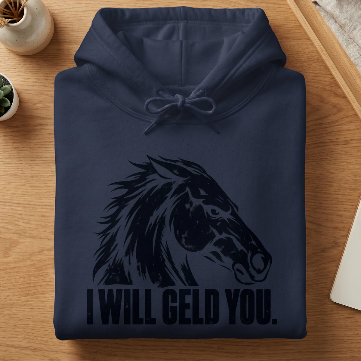 Folded dark navy hoodie featuring a stylized black horse head and the text I WILL GELD YOU.