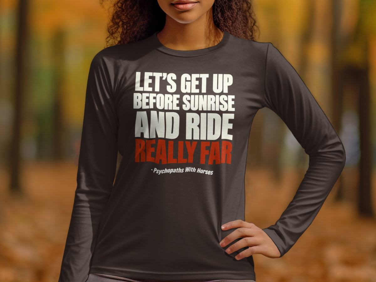 A person wearing a dark grey long-sleeve shirt with white and red text stating, "Let's Get Up Before Sunrise And Ride Really Far".