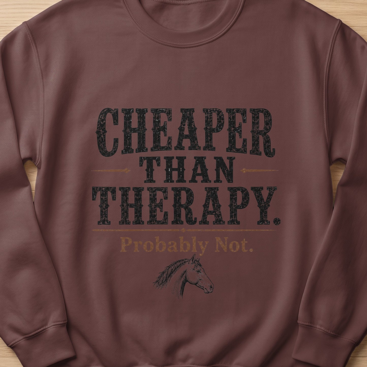 Brown sweatshirt with "Cheaper Than Therapy. Probably Not." text and horse graphic.