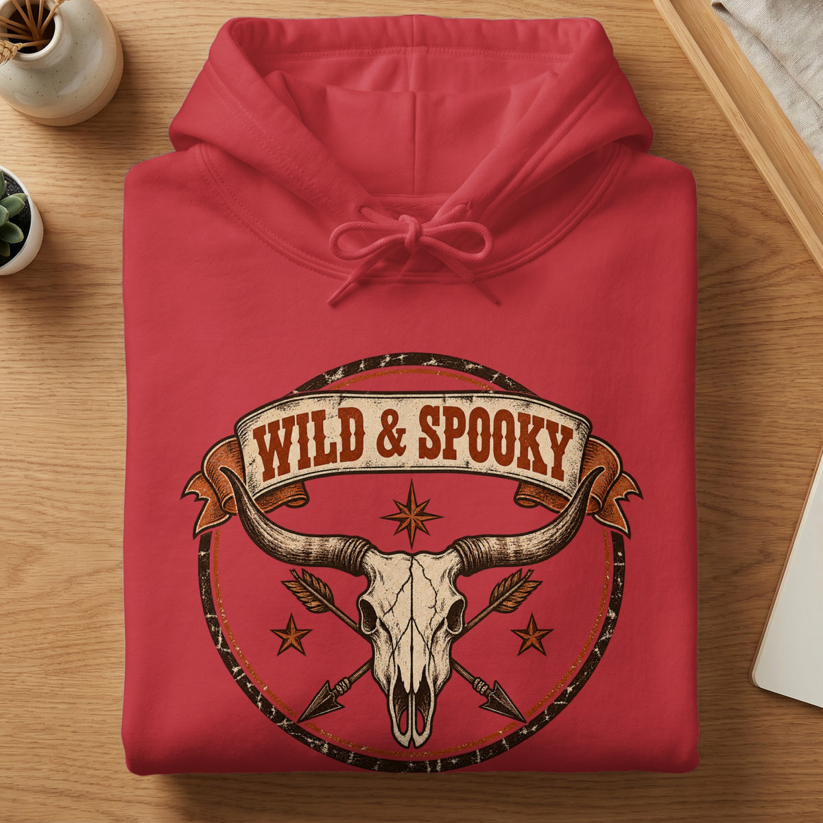 Red hoodie with "Wild & Spooky" text and longhorn skull graphic.