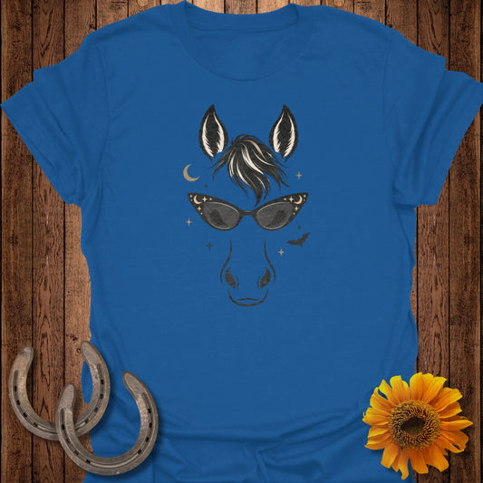 Blue t-shirt with a horse head graphic wearing cat-eye sunglasses and surrounded by stars.