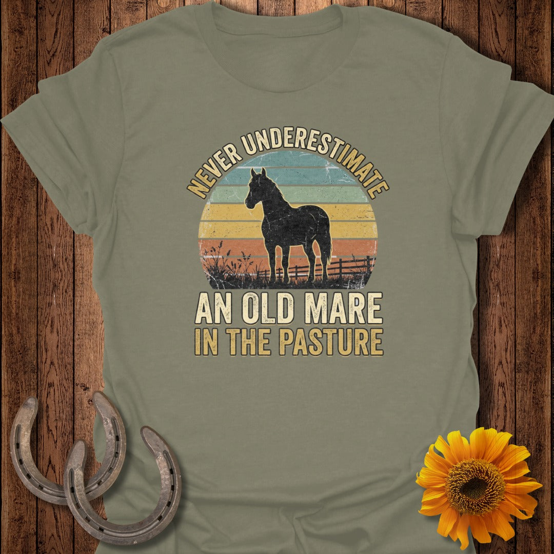 Olive green t-shirt with "Never Underestimate an Old Mare in the Pasture" text and horse silhouette.