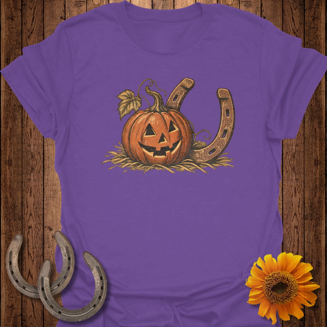 Jack-o'-lantern and horseshoe design on a purple t-shirt.