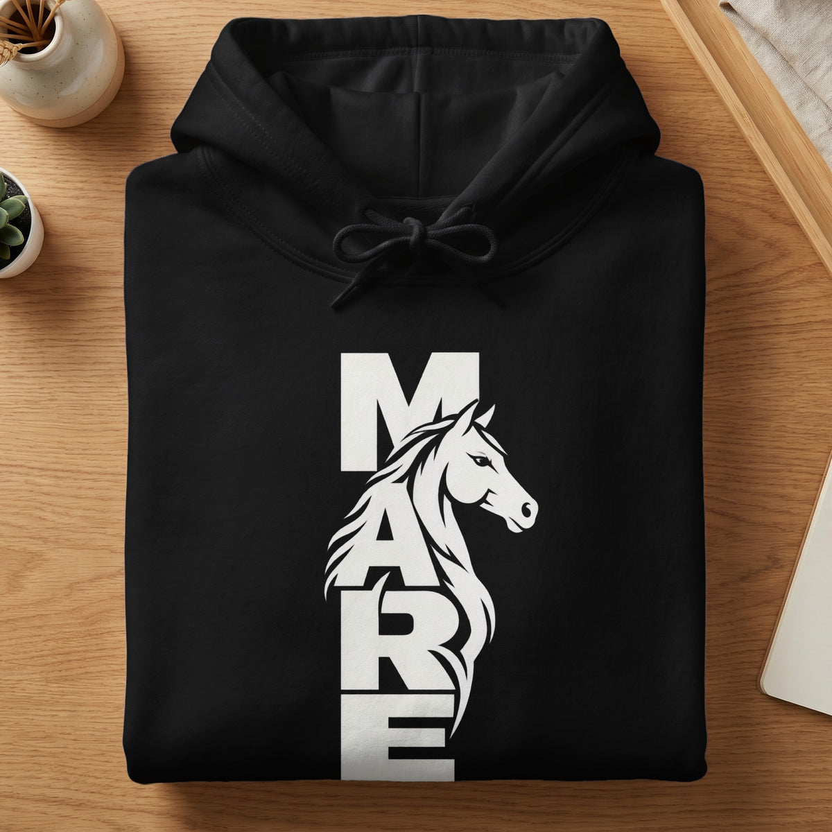A folded black hoodie featuring a white graphic combining the word MARE with a horse head silhouette.