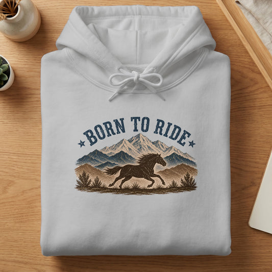 White hoodie with "Born to Ride" text and a horse running in front of mountains.