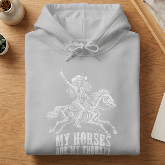 Grey hoodie with white graphic of a skeleton riding a horse and text "My Horses Are My Therapy."