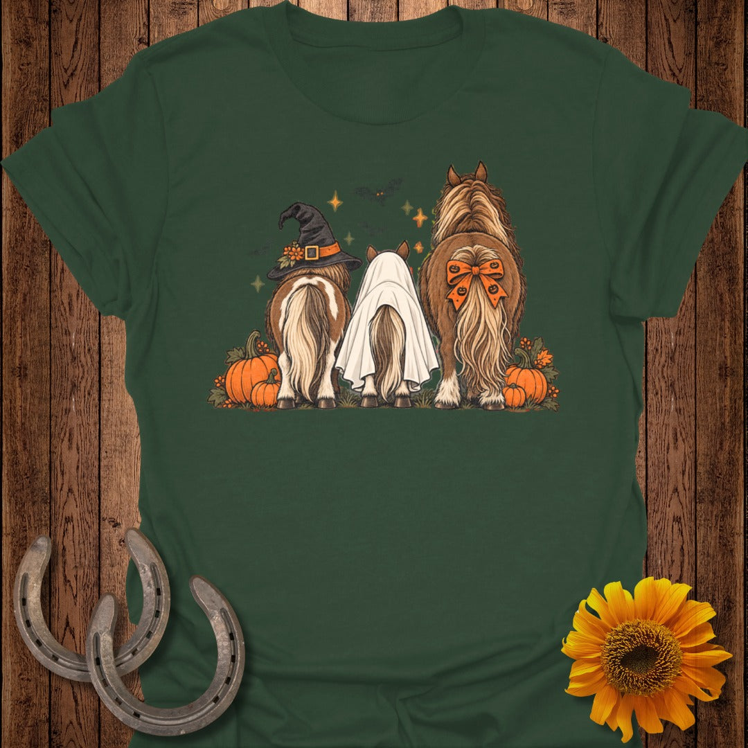 Three horses' hindquarters shown with Halloween costumes and pumpkins.