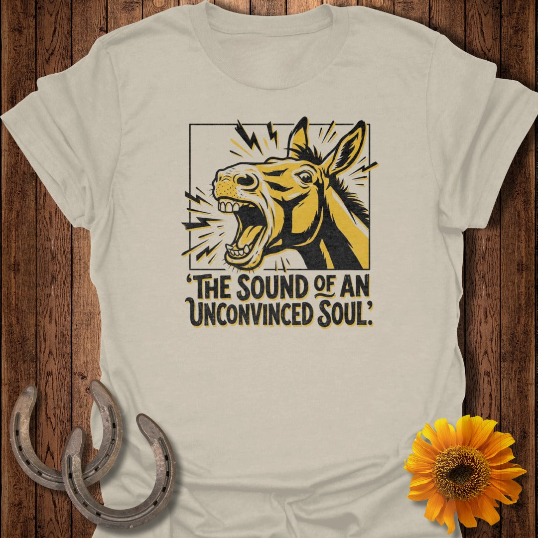 Beige t-shirt with a graphic of a donkey with text "THE SOUND OF AN UNCONVINCED SOUL?"