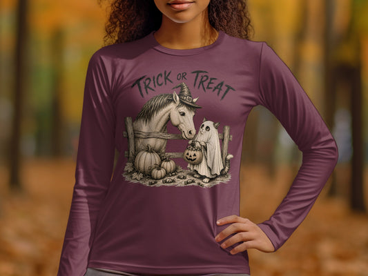 Horse in witch hat and ghost cat with candy stand behind fence.
