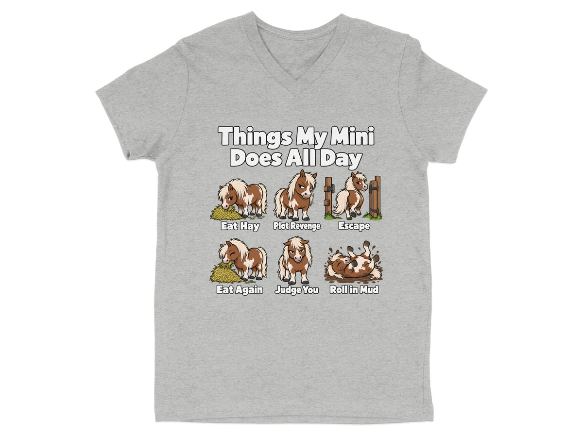 A grey V-neck t-shirt featuring cartoon illustrations and text detailing the daily activities of a miniature horse.