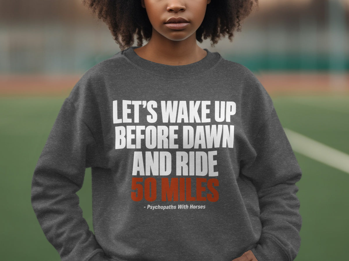 A person wears a dark gray crewneck sweatshirt printed with white and red text.