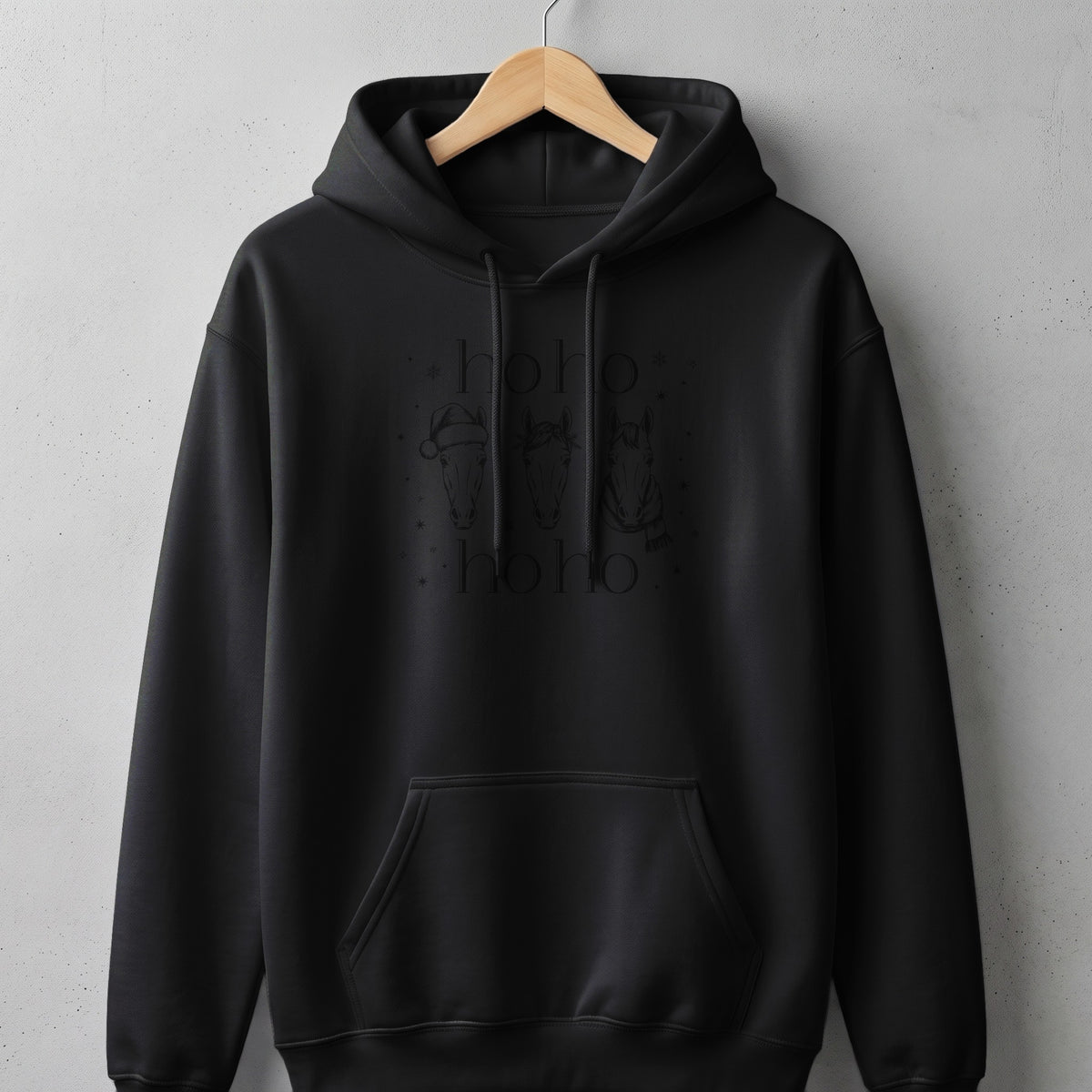 Black hoodie with "hoho" text and three horses wearing holiday accessories.