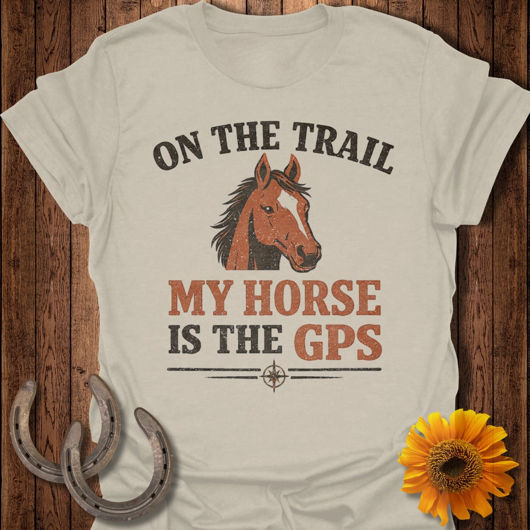 Light tan t-shirt with horse graphic and text "ON THE TRAIL MY HORSE IS THE GPS".