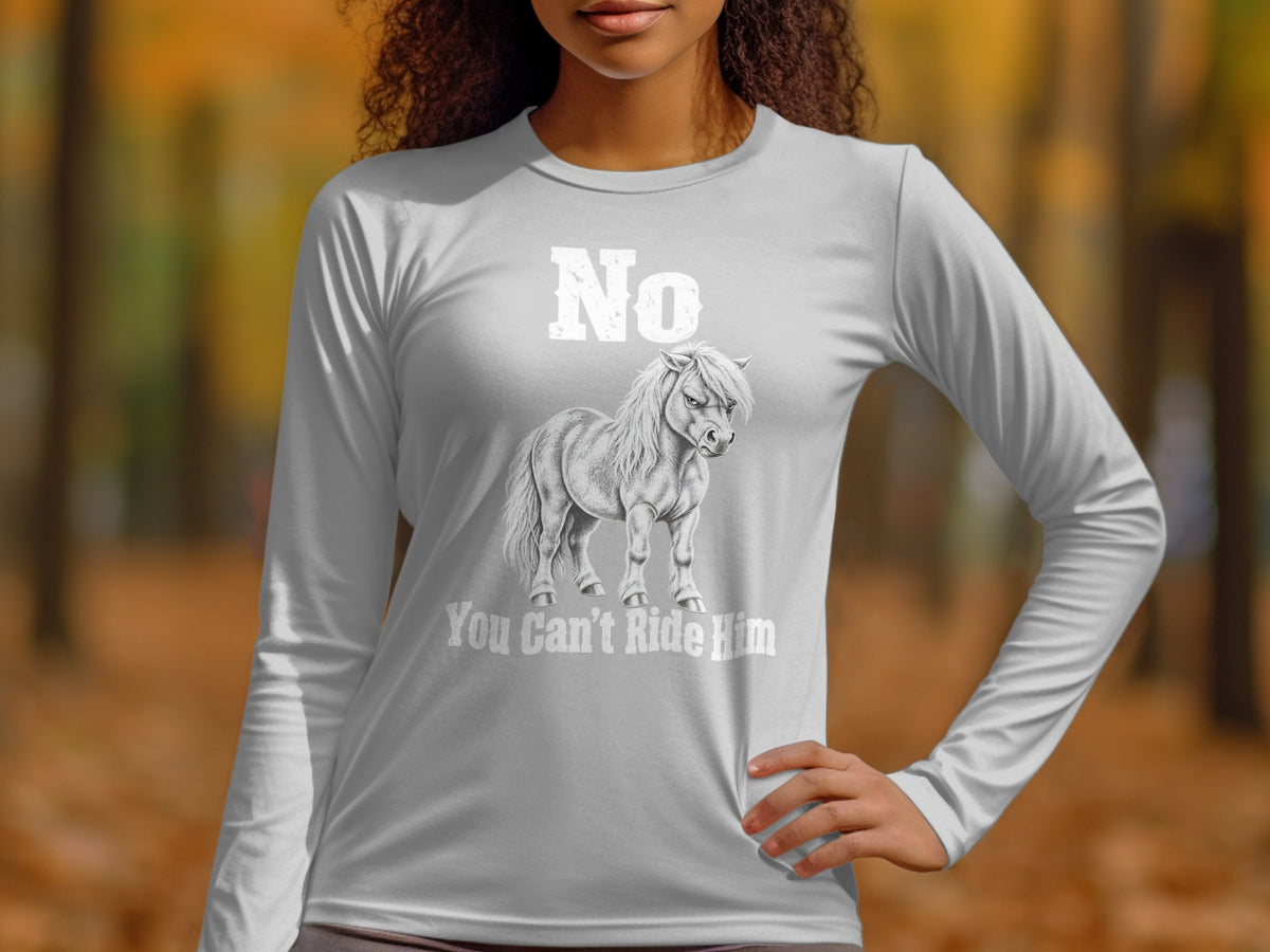 A woman wearing a grey long-sleeve shirt with an illustration of a grumpy pony and text that reads "No You Can't Ride Him".
