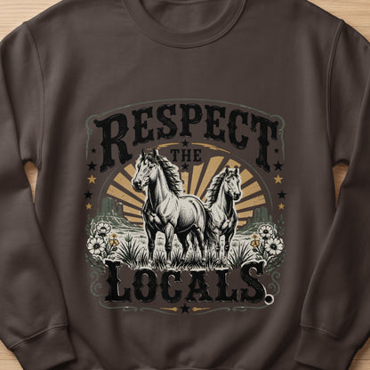 Two white horses stand in a field with text that reads "RESPECT THE LOCALS."
