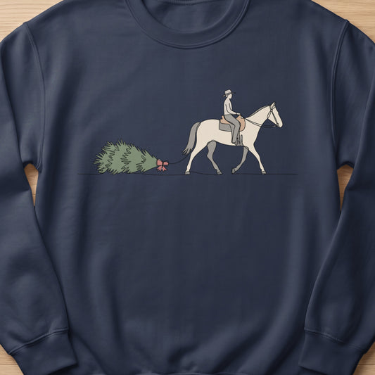Person on horseback pulls Christmas tree with red bow.