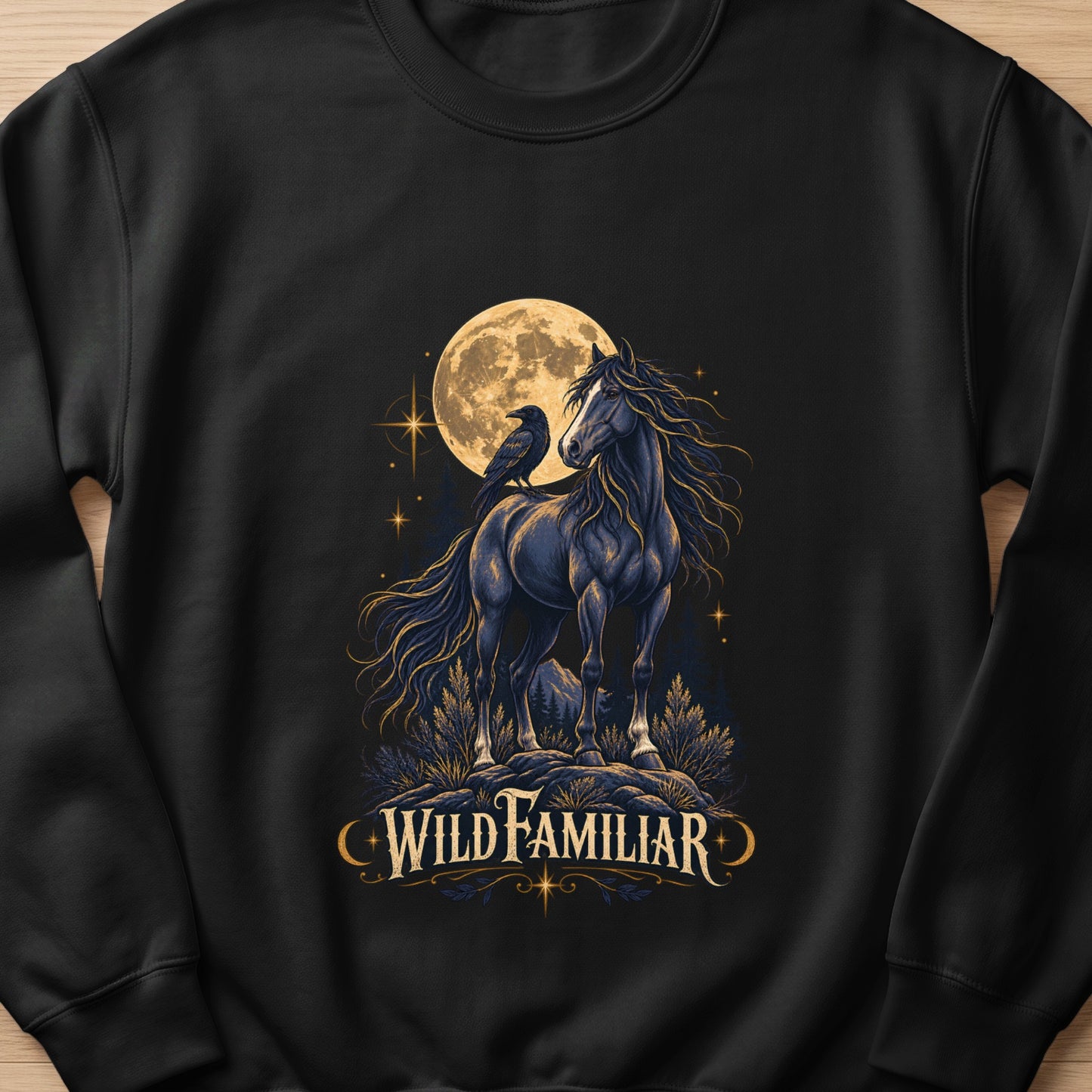 Black sweatshirt with dark horse and raven under a full moon, text reads "Wild Familiar".