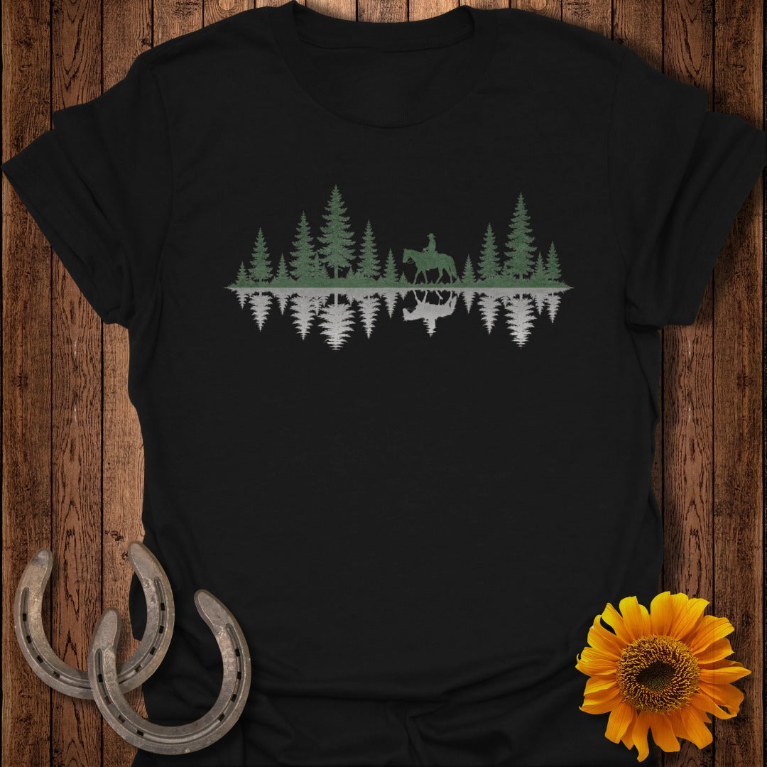 Black t-shirt with green pine trees and a horse and rider silhouette reflecting in water.