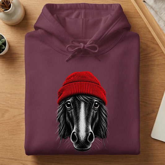 Maroon hooded sweatshirt folded on a wooden table, featuring a graphic of a horse wearing a red beanie.
