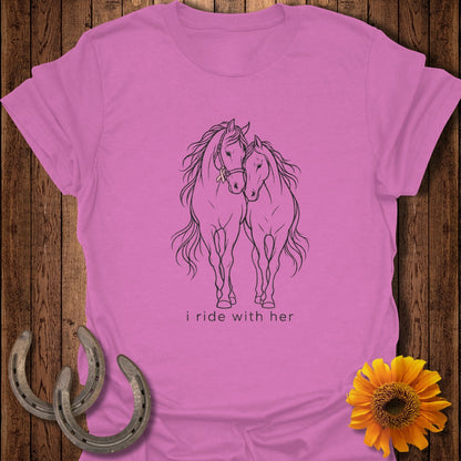 Pink t-shirt with black line drawing of two horses and "i ride with her" text.