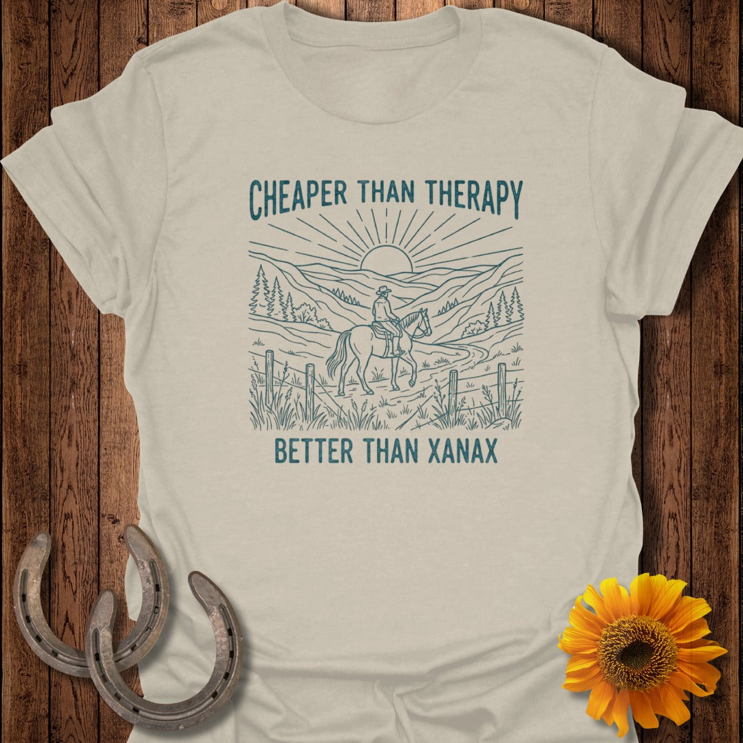T-shirt with a graphic of a horseback rider in a mountain landscape with text.
