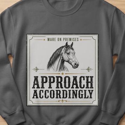 Sweatshirt with a horse illustration and text: Mare on Premises, Approach Accordingly.