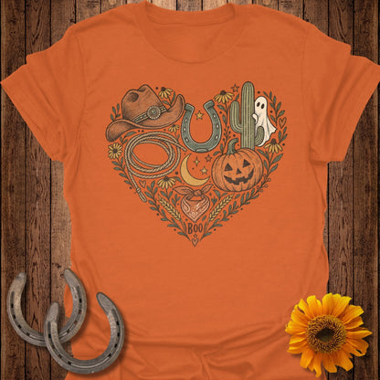 Orange t-shirt with heart graphic featuring cowboy hat, lasso, pumpkin, and ghost.