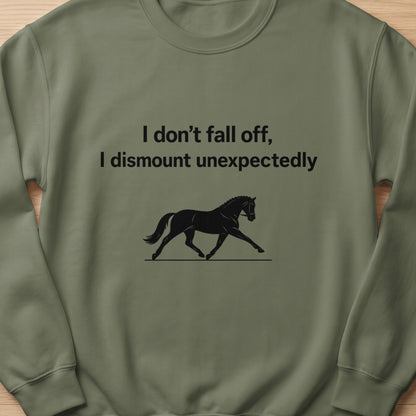 Green sweatshirt with black text "I don't fall off, I dismount unexpectedly" and horse graphic.