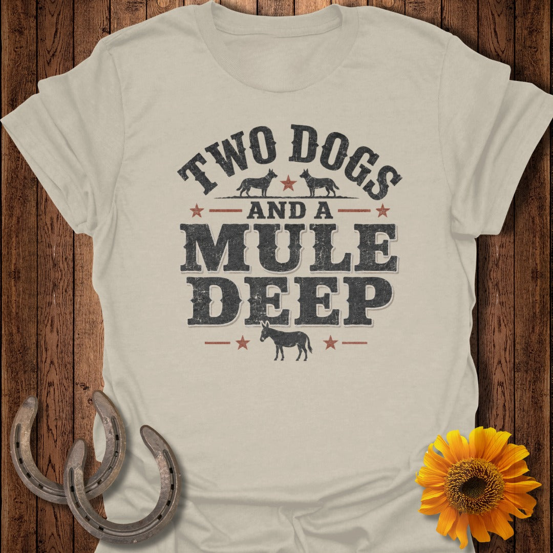 Light tan t-shirt with distressed graphic: "TWO DOGS AND A MULE DEEP" above mule.