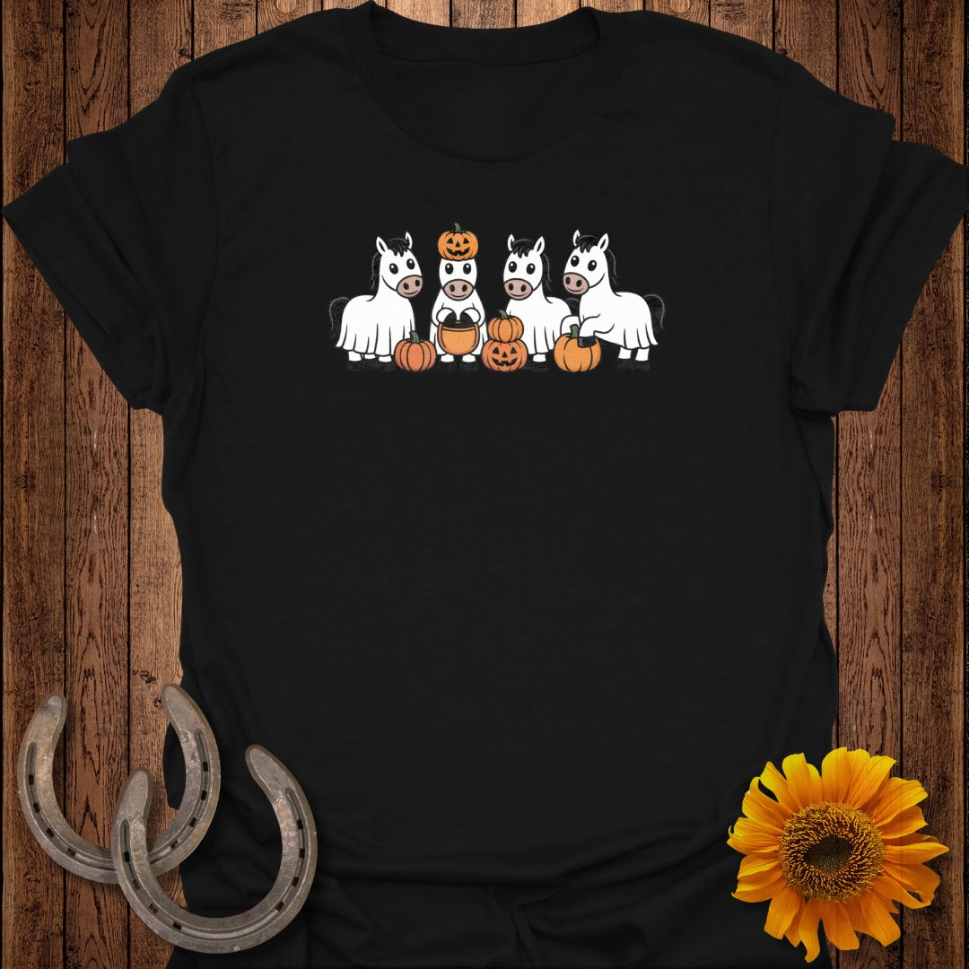 Four cartoon horses in ghost costumes with pumpkins and a sunflower on a black t-shirt.
