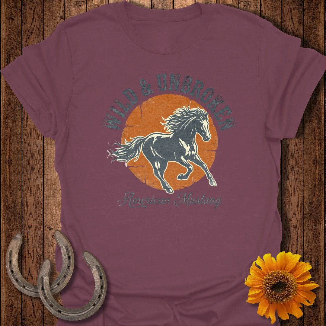 Burgundy t-shirt with graphic of a galloping horse and "Wild & Unbroken American Mustang" text.