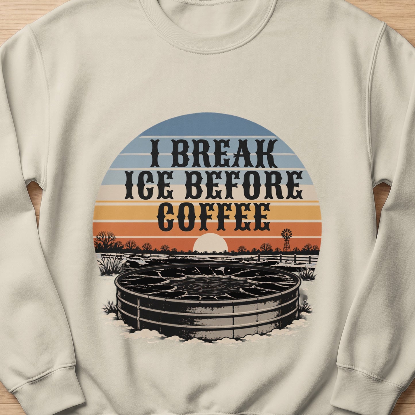Cream sweatshirt with "I Break Ice Before Coffee" text and winter livestock watering tank graphic.