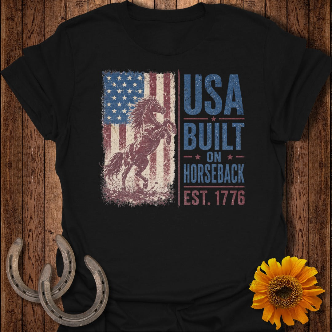 Black t-shirt with American flag, rearing horse, and "USA BUILT ON HORSEBACK EST. 1776" text.