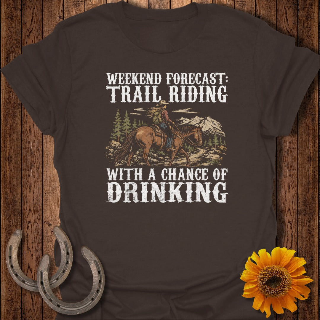 Brown t-shirt with graphic of horse rider, mountains, and text "Weekend forecast: trail riding with a chance of drinking".
