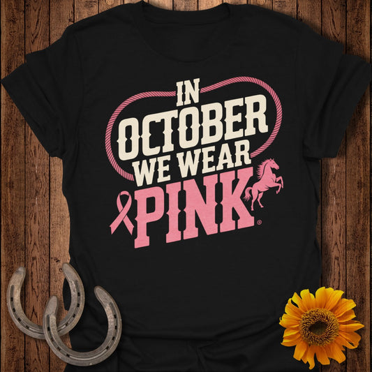 Black t-shirt with "In October We Wear Pink" text and horse graphic.