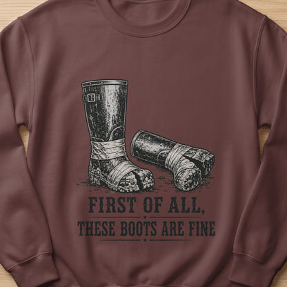 Brown sweatshirt with graphic of two worn boots and text "FIRST OF ALL, THESE BOOTS ARE FINE".