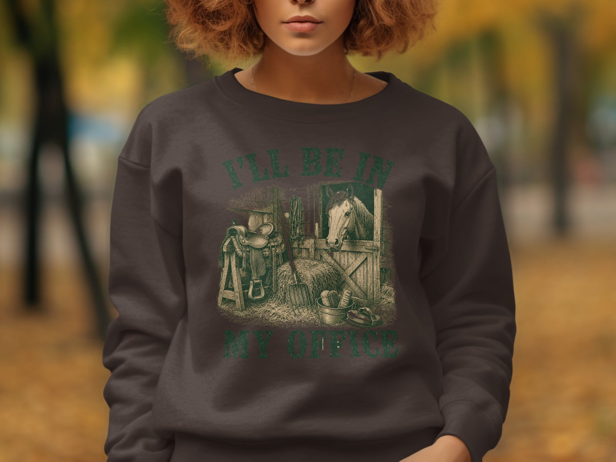 Dark brown sweatshirt with a graphic of a horse stable, saddle, and hay.