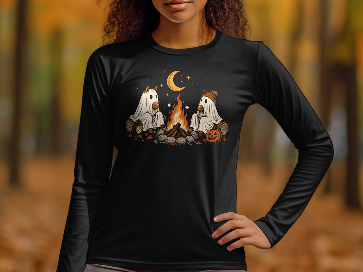 Two horses in ghost costumes roast marshmallows by a campfire under a crescent moon.