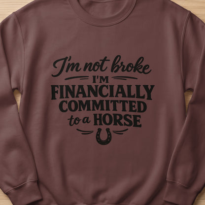 Brown sweatshirt with text "I'm not broke, I'm financially committed to a horse."