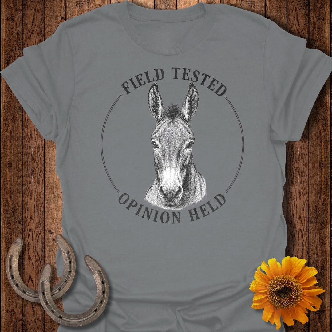 Gray t-shirt with a donkey head graphic and the text "Field Tested Opinion Held".