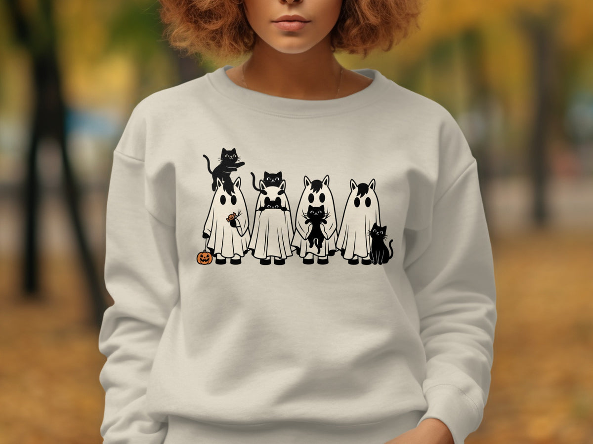 Light beige sweatshirt with black Halloween-themed cats and ghosts graphic.