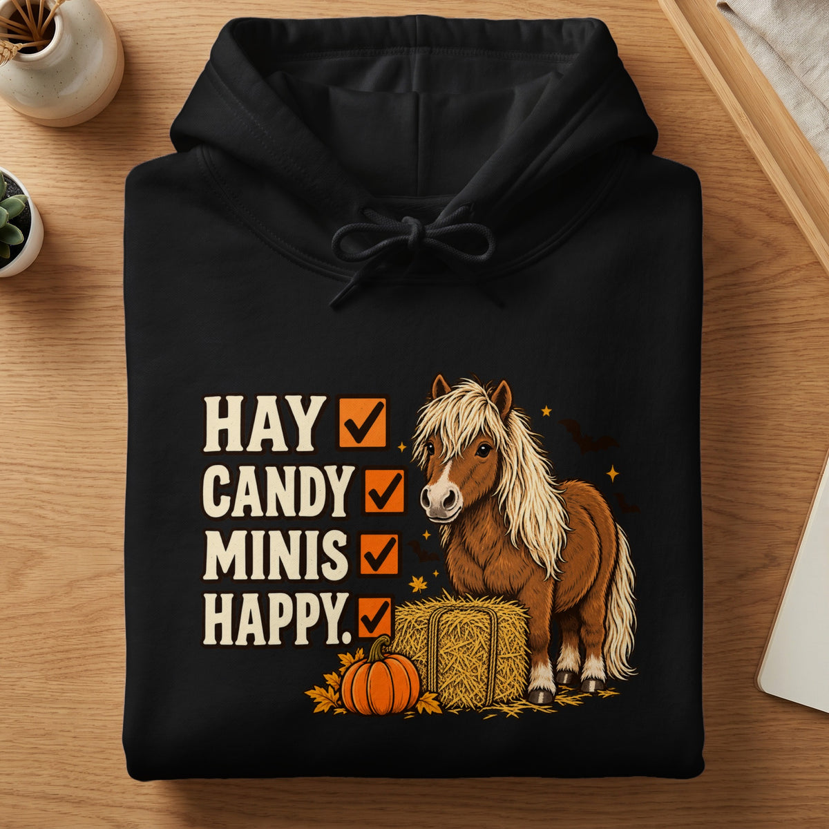 Black hoodie with "Hay Candy Minis Happy" text and a pony illustration.