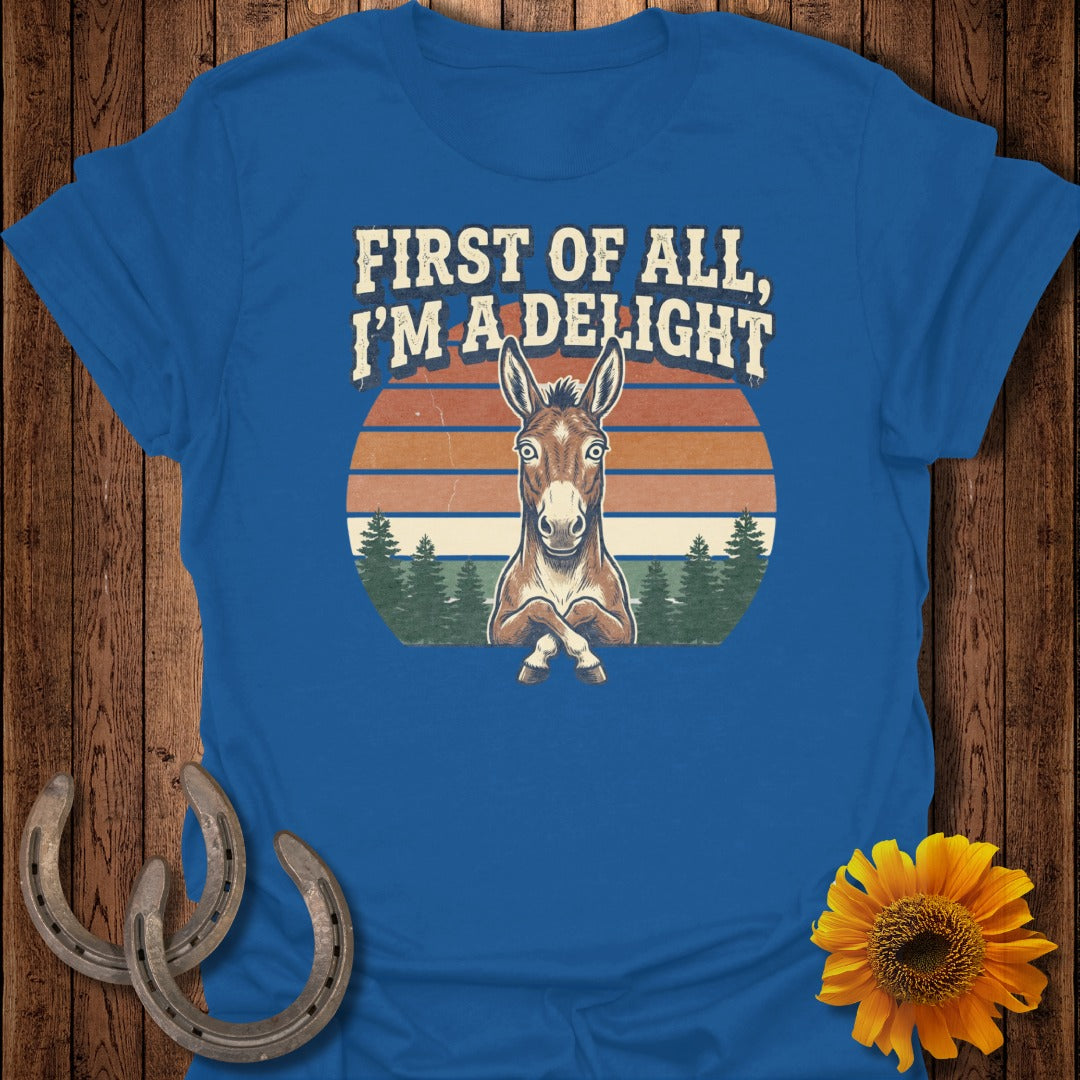 Blue t-shirt with a mule graphic and text "First of all, I'm a delight."