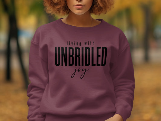 Maroon sweatshirt with text "living with UNBRIDLED joy"
