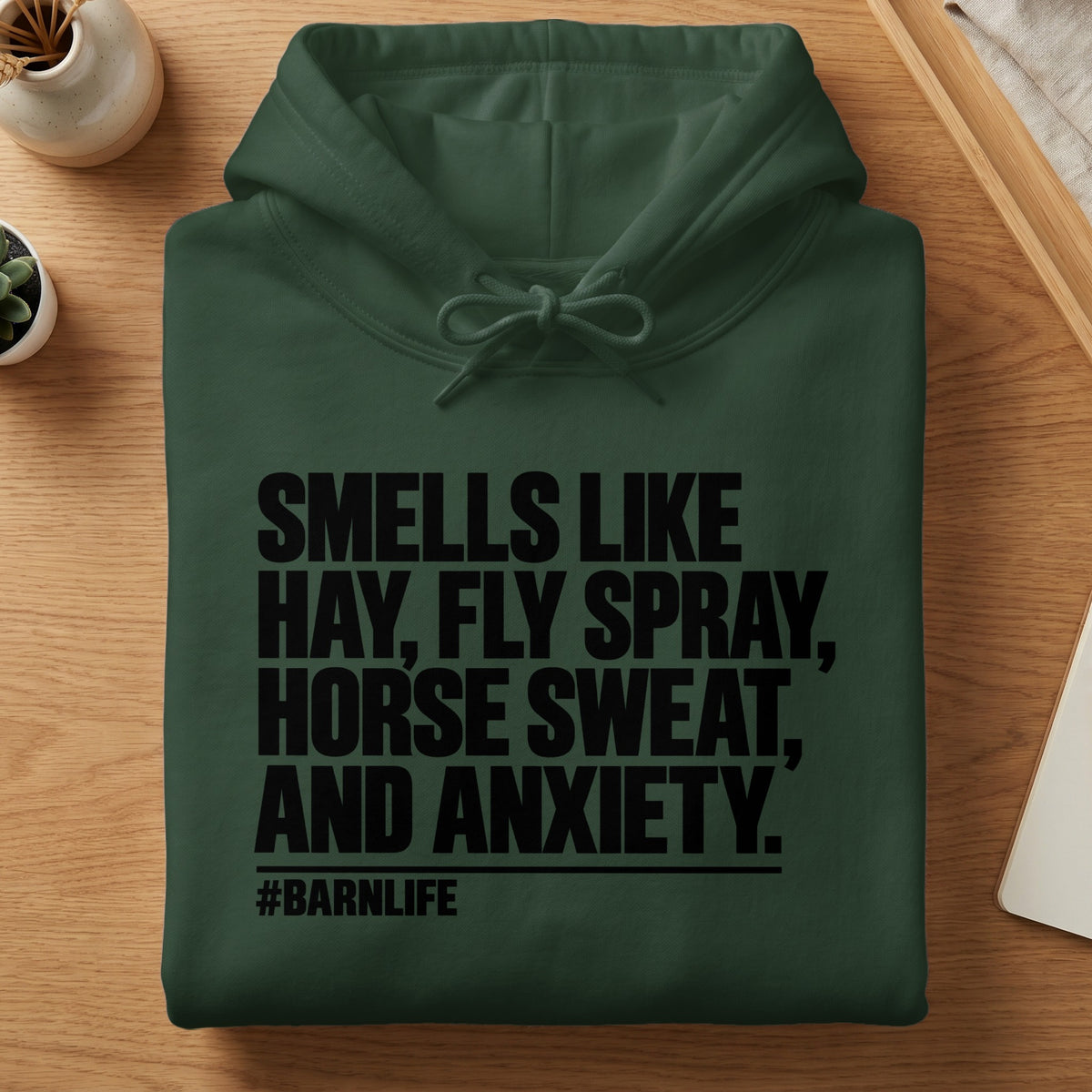 Dark green hoodie with text: Smells like hay, fly spray, horse sweat, and anxiety. #BARNLIFE