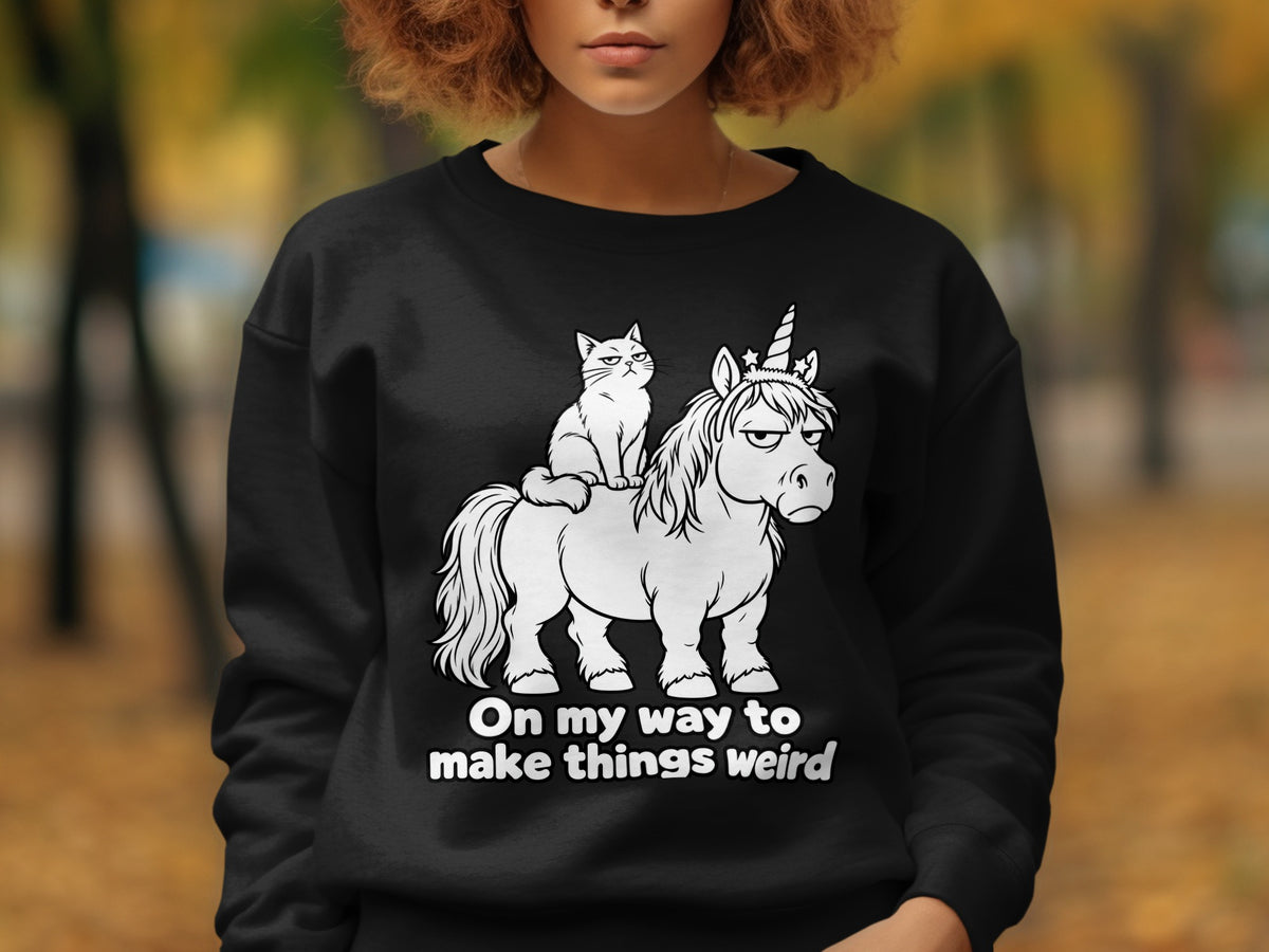 Black sweatshirt with white cartoon of a cat riding a grumpy unicorn with text.