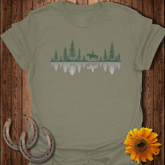 T-shirt with pine trees, a rider on horseback, and their reflection.
