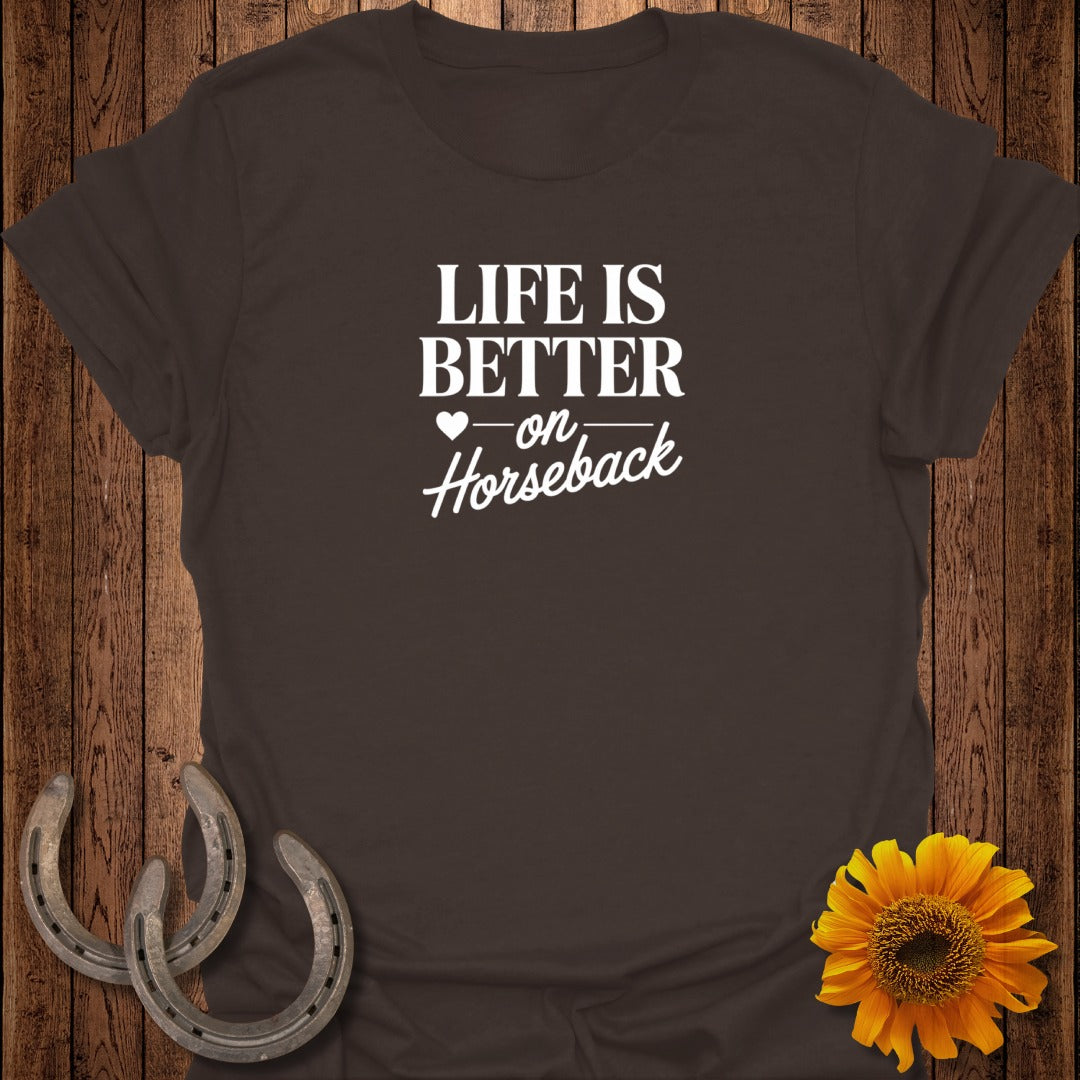 Brown t-shirt with "LIFE IS BETTER on Horseback" text, horseshoes, and sunflower.